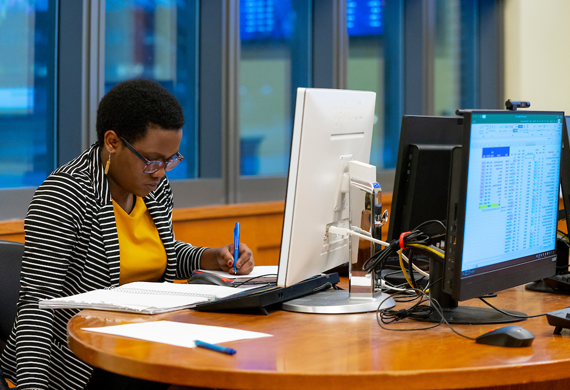 Image of a student working in the investment center on campus.